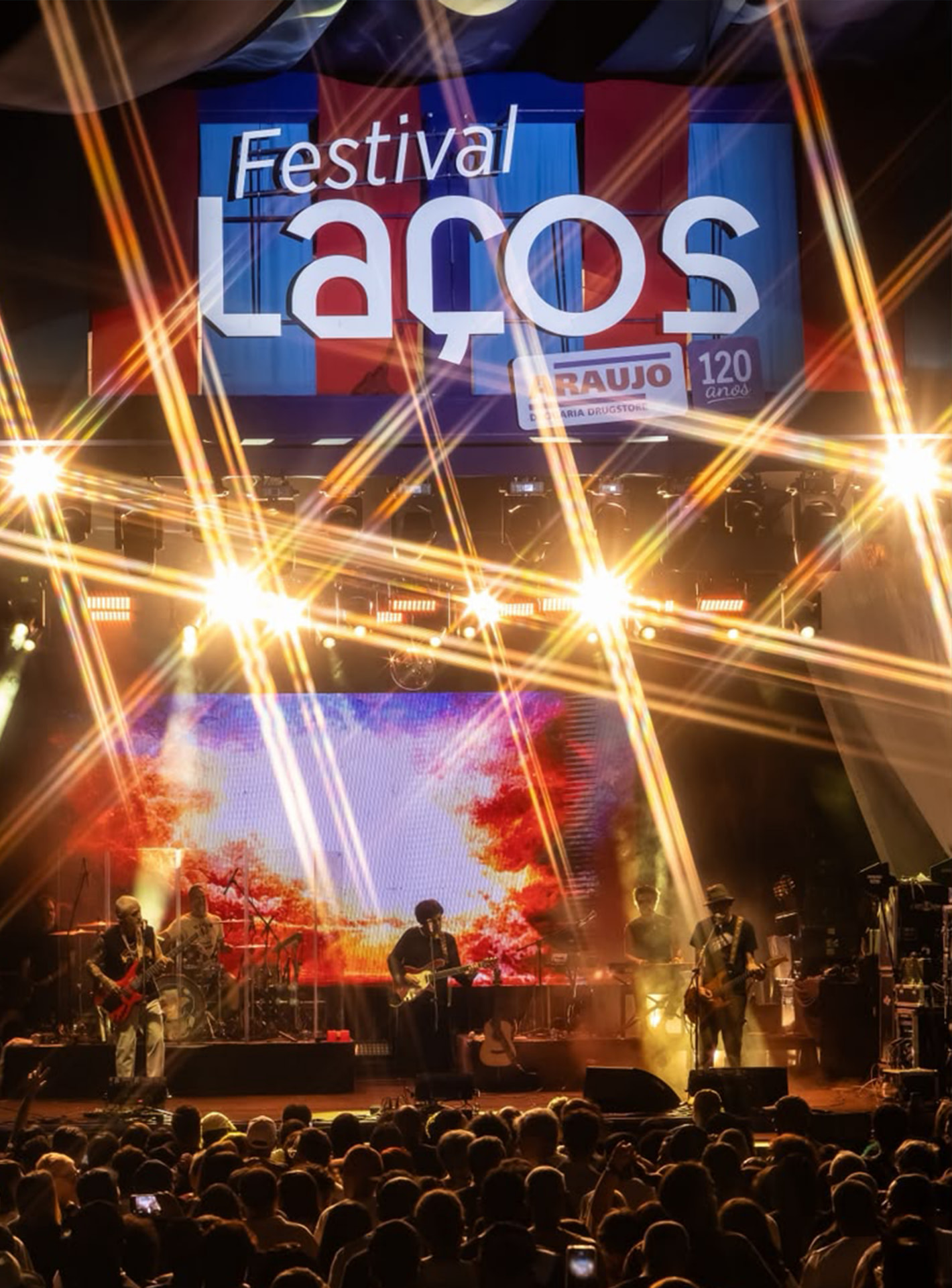 Público reunido numa praça assistindo a uma apresentação musical ao ar livre